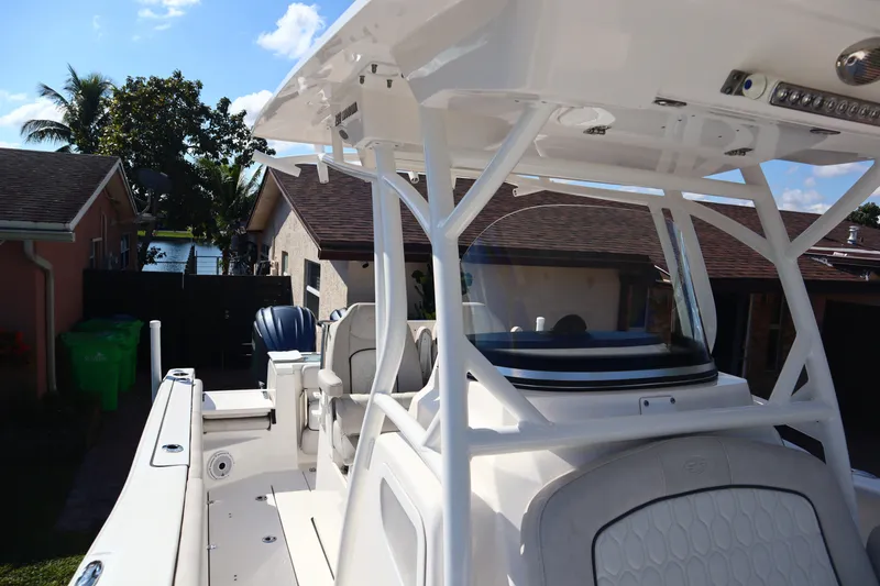 Slide: The Image of 2022 Sea Fox 288 Commander boat with T-top, parked near residential homes. - 31