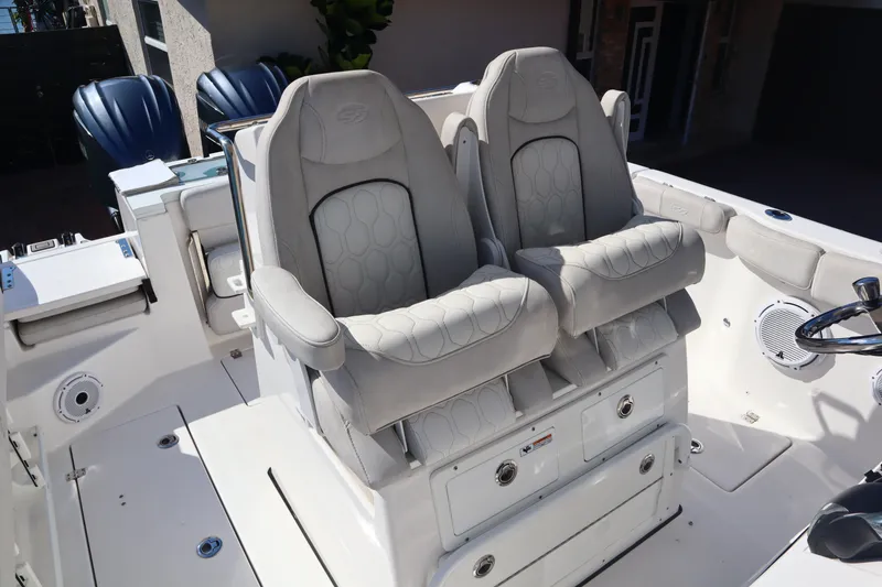 Slide: The Image of 2022 Sea Fox 288 Commander boat with dual cushioned seats and storage compartments. - 33