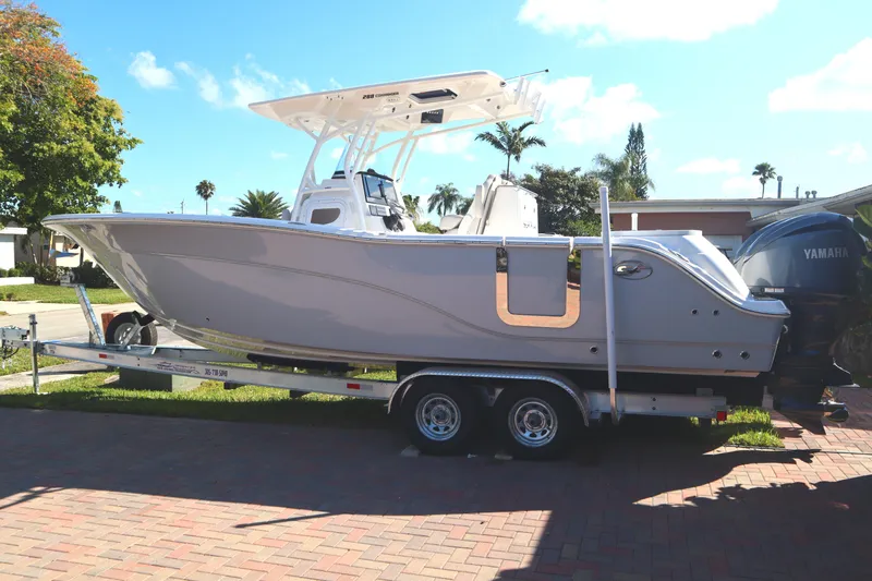 Slide: The Image of 2022 Sea Fox 288 Commander boat on trailer, parked outdoors under clear sky. - 38