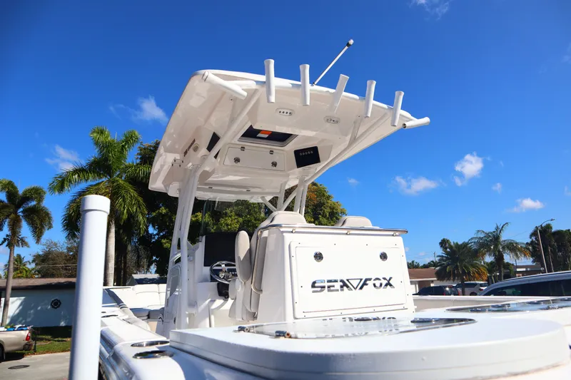 Slide: The Image of 2022 Sea Fox 288 Commander boat with T-top, parked under clear blue sky. - 4