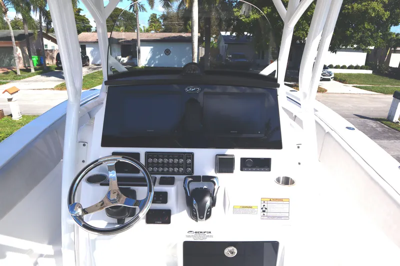 Slide: The Image of 2022 Sea Fox 288 Commander boat dashboard with steering wheel and controls. - 40