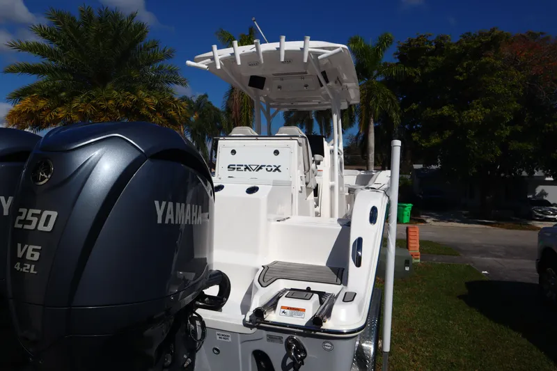 Slide: The Image of 2022 Sea Fox 288 Commander boat with Yamaha 250 V6 engines, parked outdoors. - 7