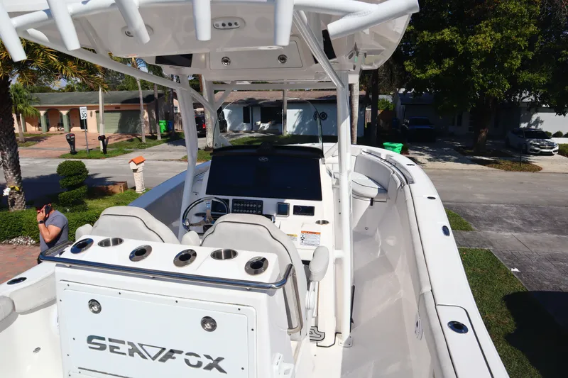 Slide: The Image of 2022 Sea Fox 288 Commander boat with helm, seating, and console in a residential area. - 8