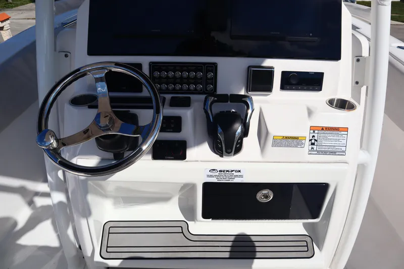 Slide: The Image of Control panel of 2022 Sea Fox 288 Commander boat with steering wheel and controls. - 9
