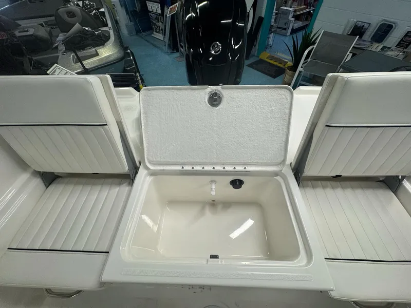 Slide: The Image of 2025 Bayliner Trophy T18 boat interior with open storage compartment. - 2
