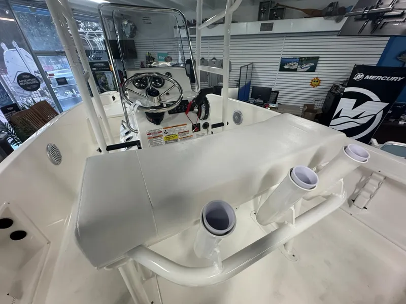 Slide: The Image of 2025 Bayliner Trophy T18 boat interior with steering console and rod holders. - 3