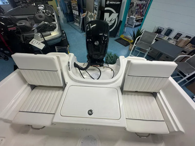 Slide: The Image of 2025 Bayliner Trophy T18 boat interior with seating and outboard motor. - 6