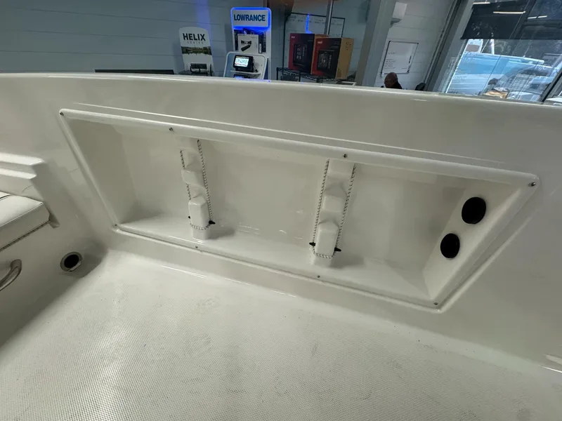 Slide: The Image of 2025 Bayliner Trophy T18 interior storage compartment with rod holders and cup holders. - 7