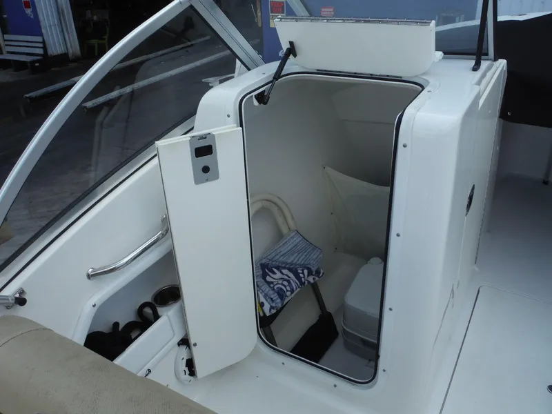 Slide: The Image of 2016 Sea Hunt Escape 235 SE boat interior with open storage compartment. - 13