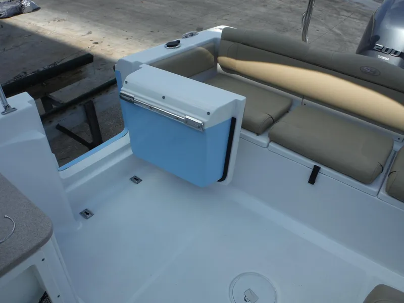 Slide: The Image of 2016 Sea Hunt Escape 235 SE boat interior with seating and storage. - 15