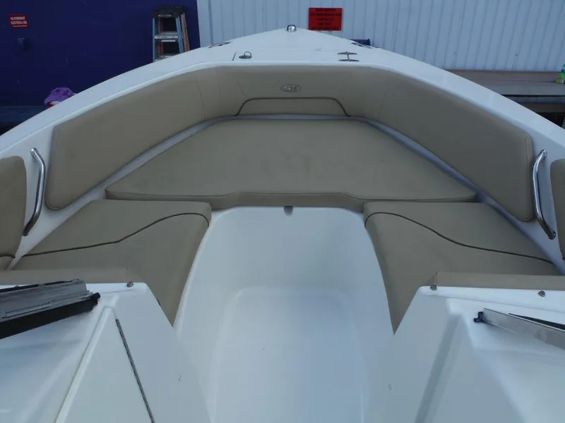 Slide: The Image of 2016 Sea Hunt Escape 235 SE boat interior with cushioned seating area. - 17