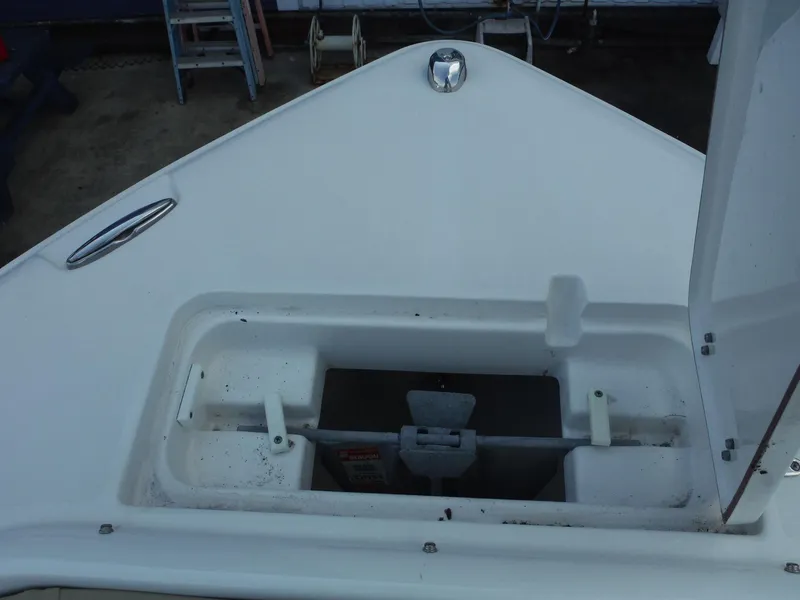 Slide: The Image of 2016 Sea Hunt Escape 235 SE boat anchor compartment, open lid, white deck. - 18