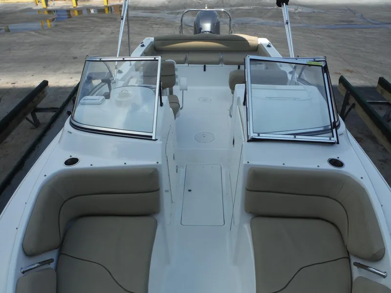 Slide: The Image of 2016 Sea Hunt Escape 235 SE boat with open deck and seating. - 19