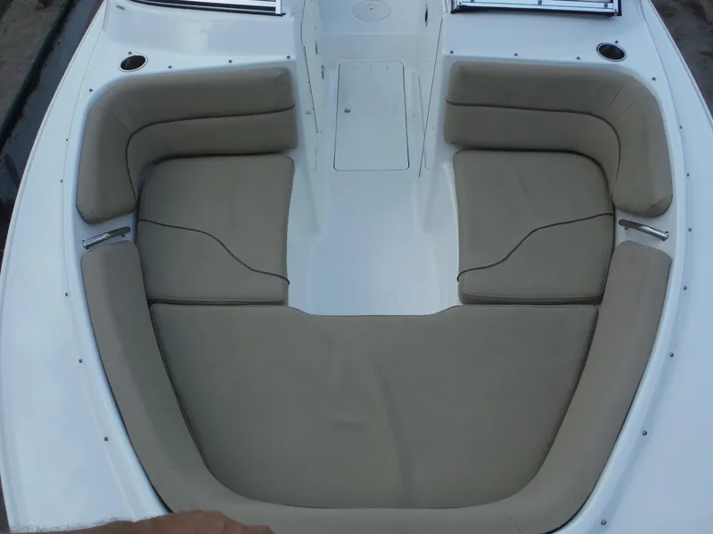 Slide: The Image of 2016 Sea Hunt Escape 235 SE boat interior with cushioned seating. - 20