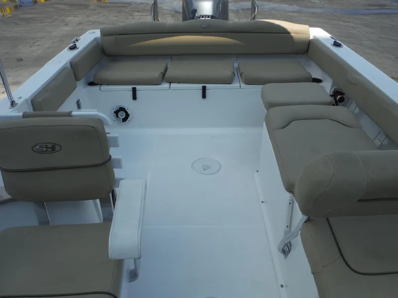 Slide: The Image of 2016 Sea Hunt Escape 235 SE boat interior with beige seating and spacious layout. - 23