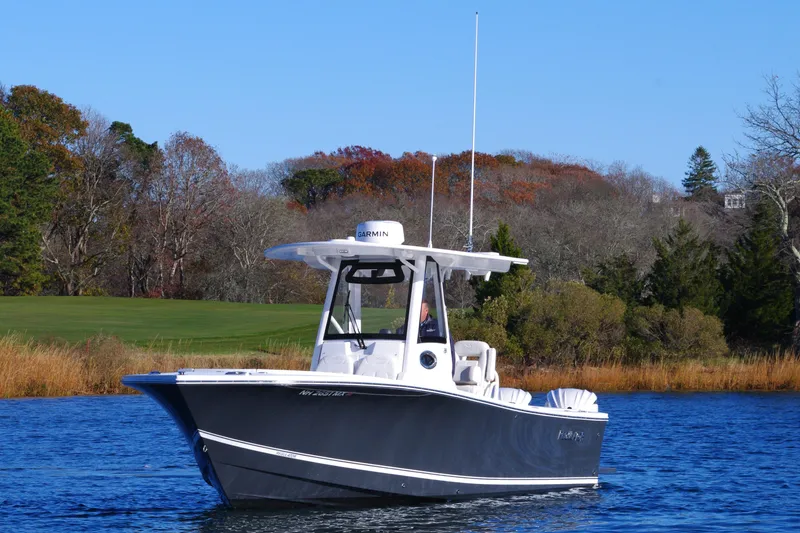 Slide: The Image of 2023 Regulator 28 boat on calm water with scenic background. - 12