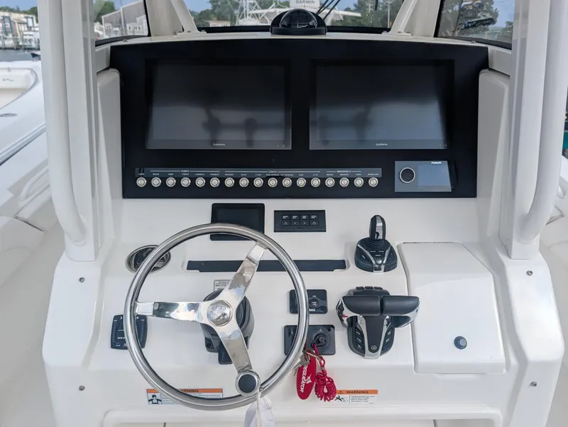 Slide: The Image of 2023 Regulator 28 boat dashboard with dual screens and steering wheel. - 15
