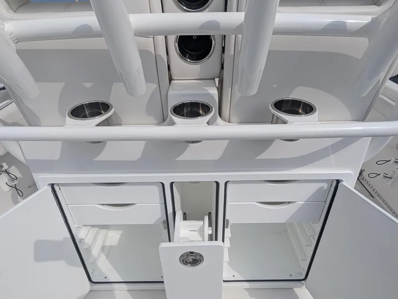 Slide: The Image of 2023 Regulator 28 boat interior with storage compartments and cup holders. - 17