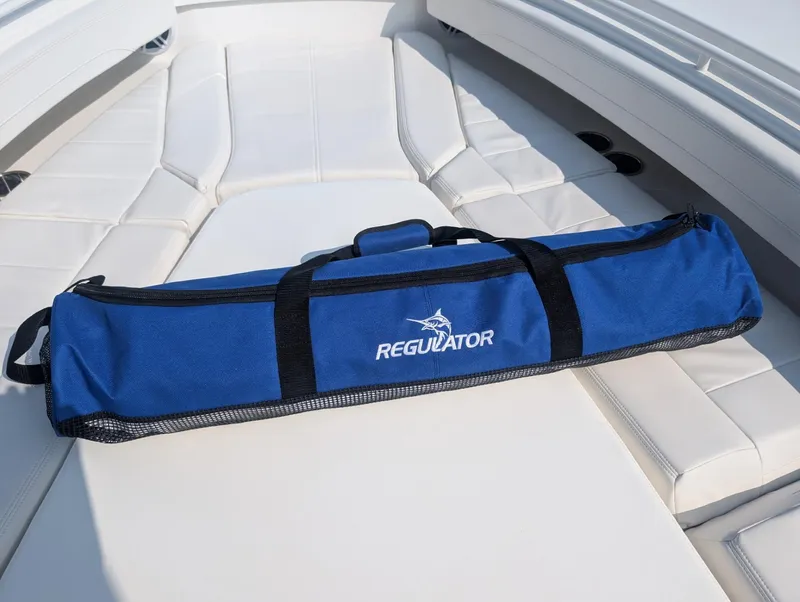 Slide: The Image of Blue Regulator bag on 2023 Regulator 28 boat's white seating area. - 20