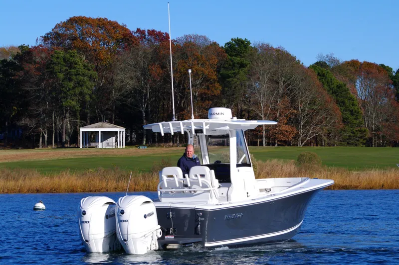 Slide: The Image of 2023 Regulator 28 boat with dual engines on a scenic lake. - 5