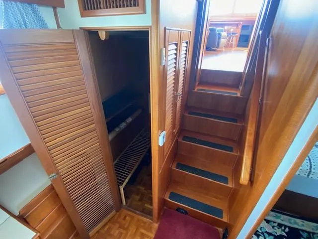 Slide: The Image of Interior of 1993 Grand Banks Classic yacht with wooden stairs and storage. - 13
