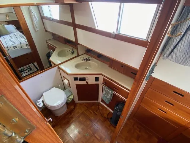 Slide: The Image of 1993 Grand Banks Classic yacht bathroom with wooden cabinetry and dual sinks. - 14