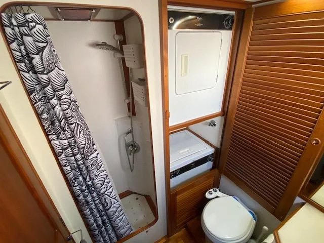 Slide: The Image of Bathroom interior of 1993 Grand Banks Classic boat with shower and toilet. - 15