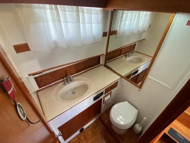 Slide: The Image of Bathroom interior of 1993 Grand Banks Classic yacht with sink, mirror, and toilet. - 18