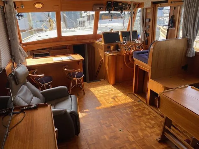 Slide: The Image of Interior of a 1993 Grand Banks Classic yacht with wooden furnishings and navigation equipment. - 2