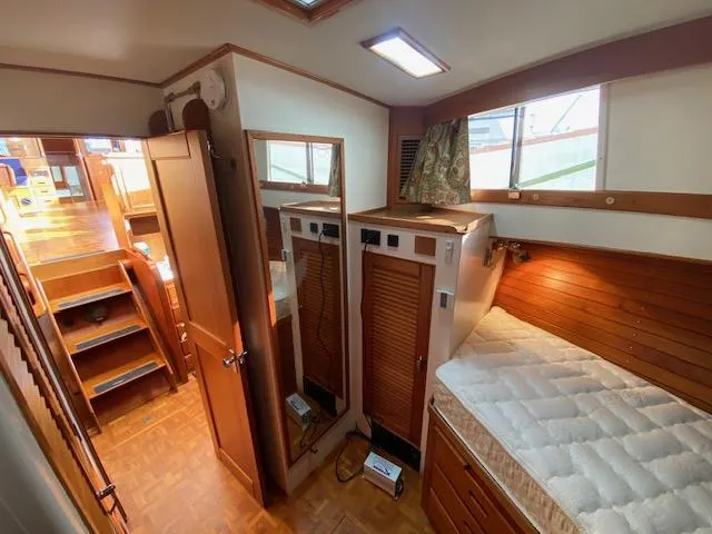 Slide: The Image of Interior of 1993 Grand Banks Classic yacht with wooden furnishings and cozy sleeping area. - 21
