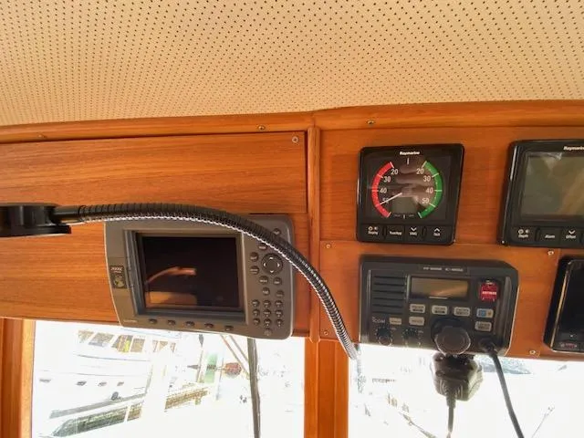 Slide: The Image of Control panel of a 1993 Grand Banks Classic boat with navigation instruments. - 23
