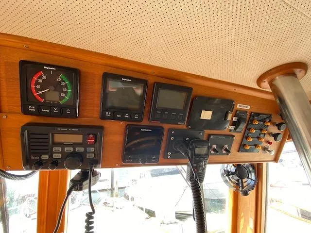 Slide: The Image of Control panel of a 1993 Grand Banks Classic boat with various navigation instruments. - 24