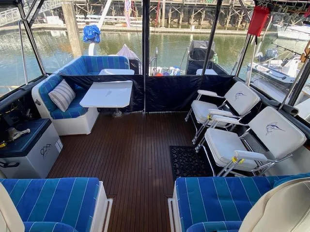 Slide: The Image of Interior of 1993 Grand Banks Classic boat with blue seating and wooden flooring. - 28