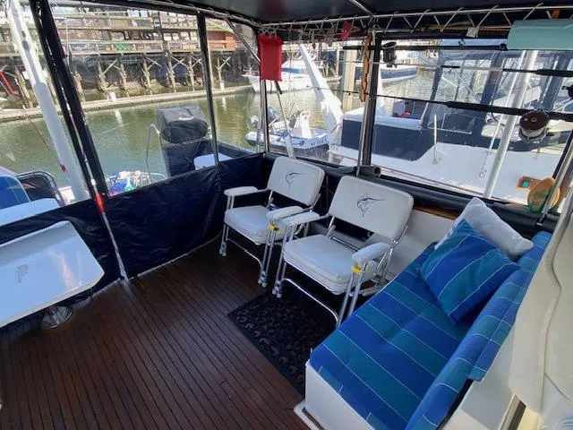 Slide: The Image of Interior of 1993 Grand Banks Classic yacht with seating and marina view. - 29