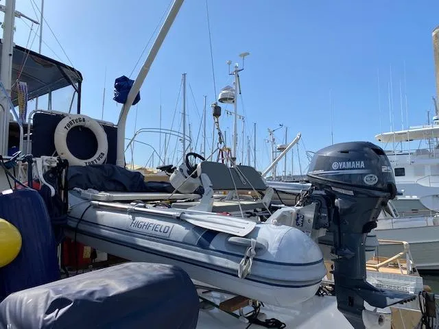 Slide: The Image of 1993 Grand Banks Classic boat with Highfield dinghy and Yamaha motor at marina. - 32