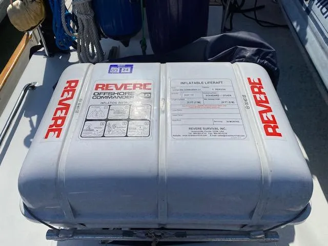 Slide: The Image of Inflatable liferaft on 1993 Grand Banks Classic boat deck, labeled "Revere Offshore Commander." - 33