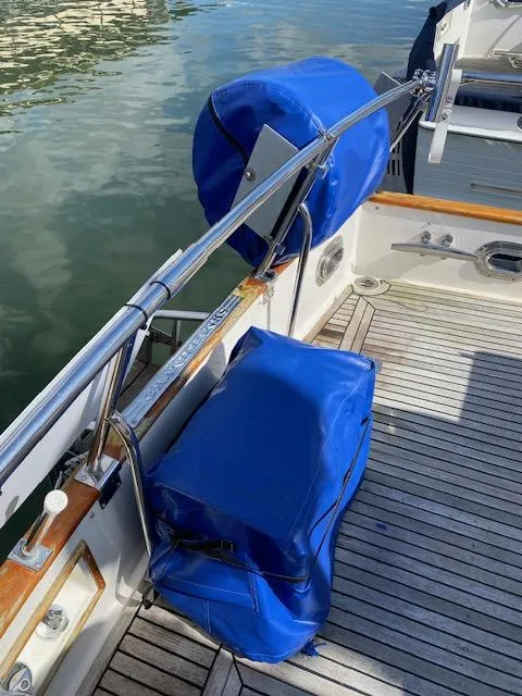 Slide: The Image of 1993 Grand Banks Classic boat deck with blue covers and wooden accents. - 35