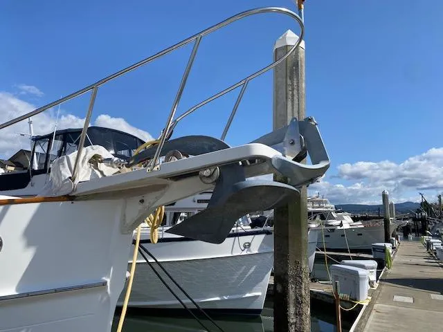 Slide: The Image of 1993 Grand Banks Classic yacht anchored at a marina under a clear blue sky. - 37