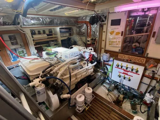 Slide: The Image of Engine room of a 1993 Grand Banks Classic boat, showcasing mechanical components and equipment. - 40