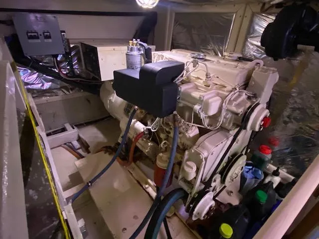 Slide: The Image of Engine room of a 1993 Grand Banks Classic boat, showcasing mechanical components and equipment. - 43