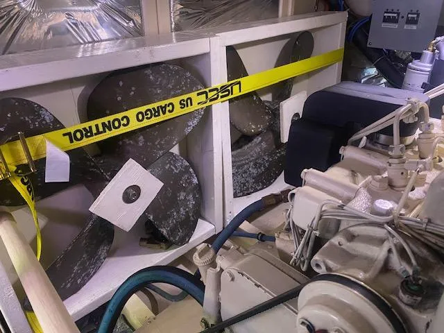 Slide: The Image of Engine room of 1993 Grand Banks Classic with propellers and caution tape. - 44