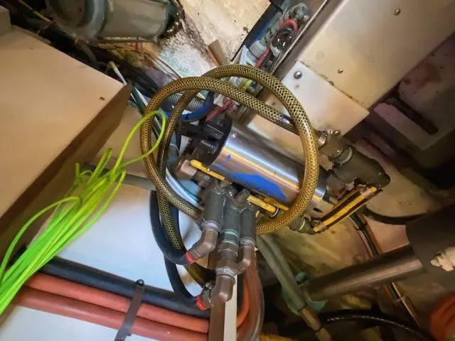 Slide: The Image of Engine room of 1993 Grand Banks Classic with hoses and mechanical components. - 45