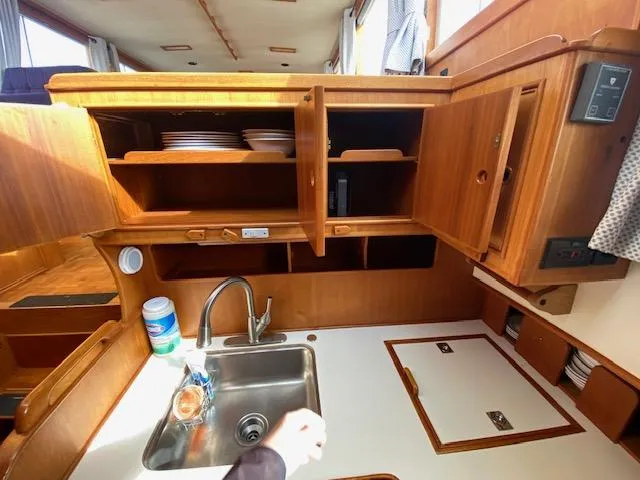 Slide: The Image of Interior of 1993 Grand Banks Classic yacht kitchen with wooden cabinets and sink. - 6