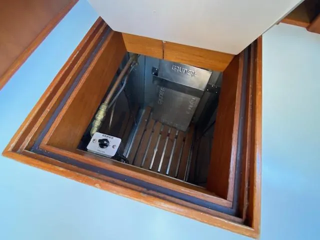 Slide: The Image of Engine compartment of a 1993 Grand Banks Classic boat, featuring wooden framing and metal components. - 9