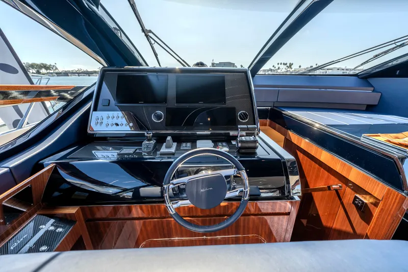 Slide: The Image of 2024 Riva 66' Ribelle yacht cockpit with sleek design and advanced navigation systems. - 21