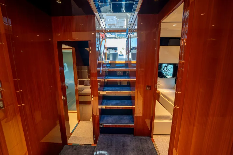 Slide: The Image of Luxurious interior of 2024 Riva 66' Ribelle yacht with polished wood and modern design. - 25