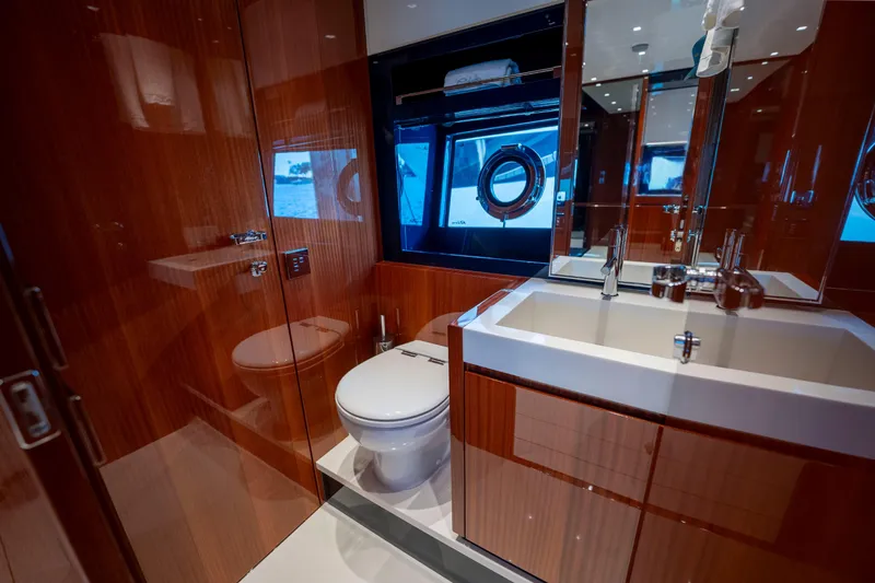 Slide: The Image of Luxurious bathroom on 2024 Riva 66' Ribelle yacht with modern fixtures and wood finish. - 31