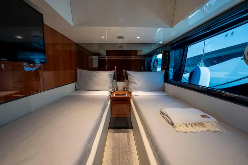 Slide: The Image of Luxurious interior of 2024 Riva 66' Ribelle yacht with twin beds and elegant decor. - 32