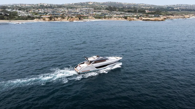 Slide: The Image of 2024 Riva 66' Ribelle yacht cruising near scenic coastline. - 34