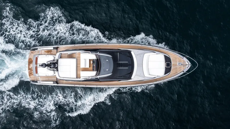 Slide: The Image of 2024 Riva 66' Ribelle yacht cruising on open water, aerial view. - 4